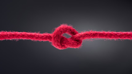 knotted red rope black background