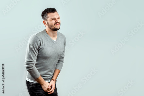 A Young Attractive Man Feels Pain In His Groin Arms Folded Between His Legs Experiencing Pain Male Problems Potency Stock Foto Adobe Stock