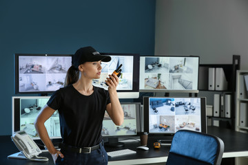 Sticker - Security guard with portable radio transmitter in surveillance room