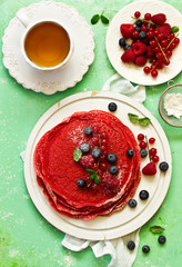 Wall Mural - Pancakes are red velvet, with berries and cream. Valentine's Day. Selective focus.