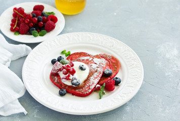 Poster - Pancakes red velvet in the form of a heart with berries and cream. Valentine's Day. Selective focus.