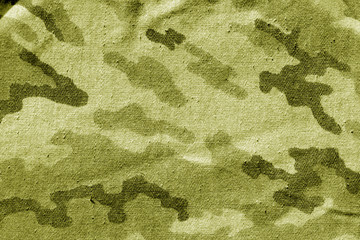 Dirty camouflage cloth in yellow tone.