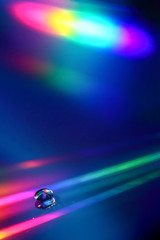 water drop on a compact disc with refraction patterns
