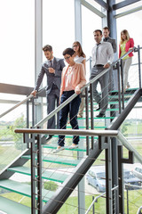 Wall Mural - business people walking down stairs.