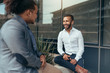 © JonoErasmus - Two trendy businessmen talking and laughing casually outside
