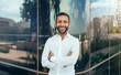 © JonoErasmus - Portrait of a young confident smiling indian man with his arms crossed looking into the camera