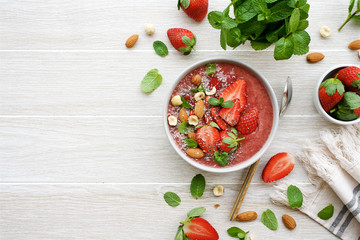 Wall Mural - Smoothie bowl with  strawberry, nuts, coconut and chia seeds. Flat lay Healthy lifestyle, healthy eating, dieting concept 