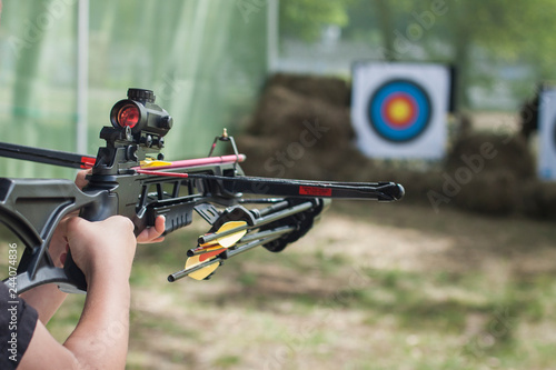 Photographie The shooter directed the crossbow towards the colored target