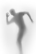 Happy dancing man body silhouette behind a diffuse surface. Face, head, fingers and hand can be seen.