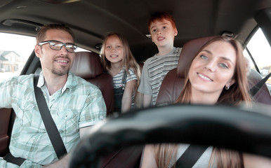 Wall Mural - young parents go in the car