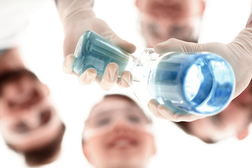 Wall Mural - image is blurred. beakers in hand, and scientists