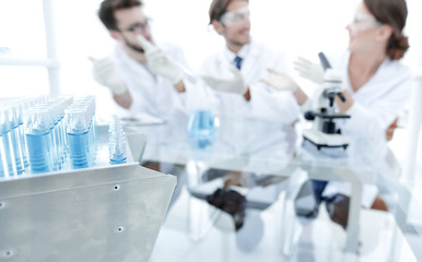 Wall Mural - background image of scientists studying blue liquid in a flask
