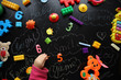 © dyageleva - Children's toys and accessories on a black background. View from above
