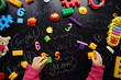 © dyageleva - child is playing with bright toys on a black background