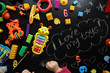 © dyageleva - child is playing with bright toys on a black background