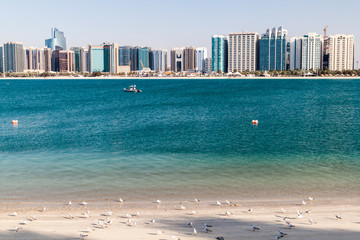 Wall Mural - View of the skyline of Abu Dhabi from the Marina Breakwater beach, United Arab Emirates