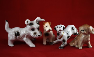 Wall Mural - four porcelain dogs  on a red background