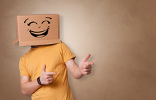 Young Man With Happy Face Illustrated Cardboard Box On His Head
