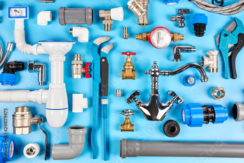 Fotomural plumbing tools and equipment on blue background top view.