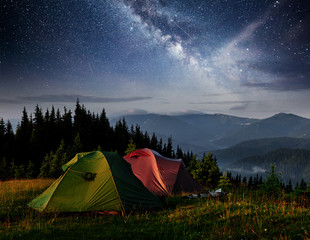 dairy star trek above the tents. dramatic and picturesque scene at night mountains. carpathian ukrai