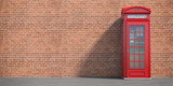 Fototapeta Fototapeta Londyn - Red phone booth on brick wall background. London, british and english symbol. Space for text