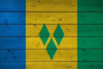 Wall Mural - Flag of Saint Vince and the Grenadines on wooden background, surface. Wooden wall, planks. National flag