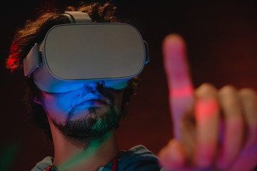 Close-up portrait of young bearded man in virtual reality glasses.