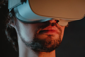Close-up portrait of young bearded man in virtual reality glasses.