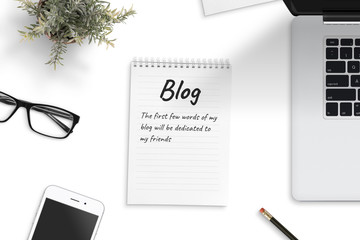 Wall Mural - notepad with few words of first blog surrounded with laptop computer, smart phone, pencila, plant, g