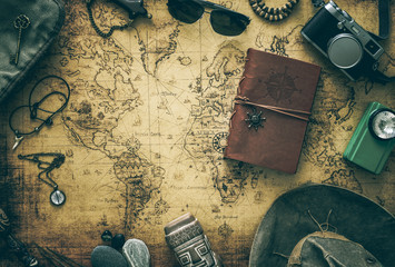 Fototapete - Old map, vintage travel equipment and souvenirs from the travel around the world / place for your text