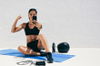Fitness woman taking a selfie during workout