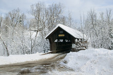 A Snow Blanketed Emily's Covered Bridge In Stowe Vermont, USA