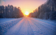 Sun over siberian rural empty road under the snow at morning time