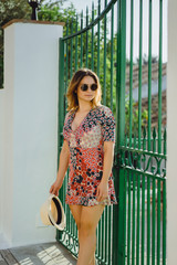 Wall Mural - a young beautiful woman in a short dress walks through the streets of a small European town.