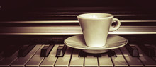 Cup Of Coffee On Piano Keys With Copy Space, Concept Of Coffee Break Musical Pause