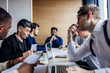 © alfa27 - Group of strategy managers reading last business reports from exchanges on laptop and pesonal computers during business meeting coloborating together in strategy session.