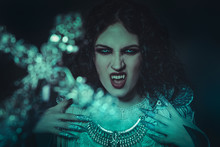 Fear Of The Cross Vampire, Demonic Woman Dressed In White Lace And Silver Jewelry. Has Fangs And Thick Brown Hair