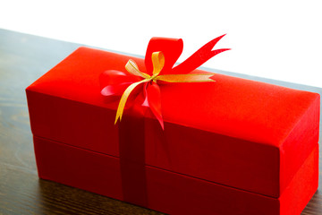 Red gift box with red and gold ribbon