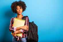 Young African Student With Backpack On The Back On Blue Background