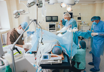 Wall Mural - Process of trauma surgery operation. Group of surgeons in operating room with surgery equipment.