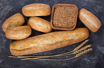 Sticker - Fresh bread with wheat ears on dark table