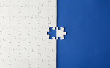 White Puzzles On A Blue Background With One Missing Piece