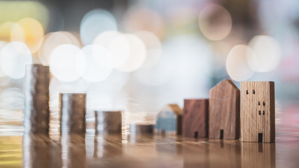 Wood house model and row of coin money on white background, Real Estate market, Trading Estate, Mortgage Concepts