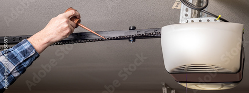 Man Puts Oil On A Squeaky Chain From A Garage Door Opener Buy