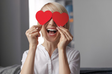 Wall Mural - Laughing female with hearts near eyes