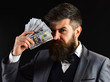 © Volodymyr - Wealthy and confident. Bearded man with dollar banknotes. Successful businessman hold cash money. Rich man with beard in formal wear. Business and finance. Earning money. Growing a business