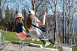© cwzahner - Two gorgeous blonde girls swinging on a swing on a sunny summer day
