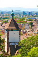 Wall Mural - View on the ancient buildings with the Schwabentor clock tower in Freiburg im Breisgau, Germany on a sunny day.