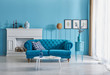 © UnitedPhotoStudio - Blue room, blue sofa and pillow, vase of plant with white fireplace, orange lamp and frame decoration.