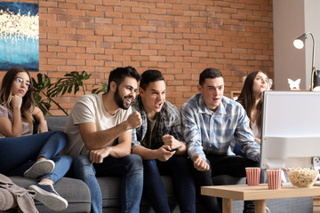 Canvas Print - Bored girls and emotional guys watching sports on TV at home